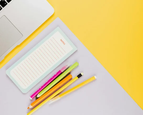 pexels-karola-g-5208308 Notebook, pencils, and stationery on a yellow desk.
